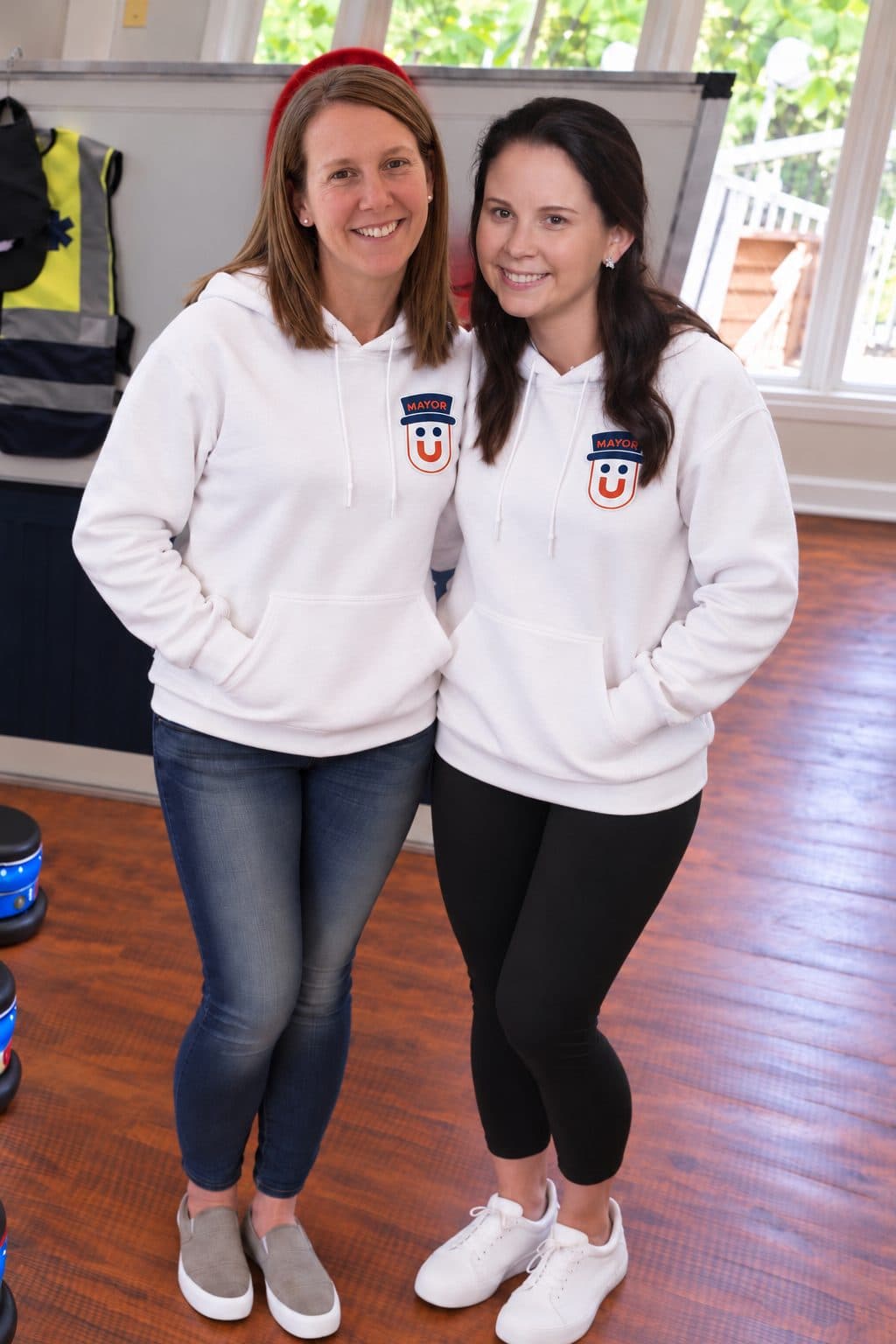 The two founders of Kids Run the Town standing in the Emergency Services station